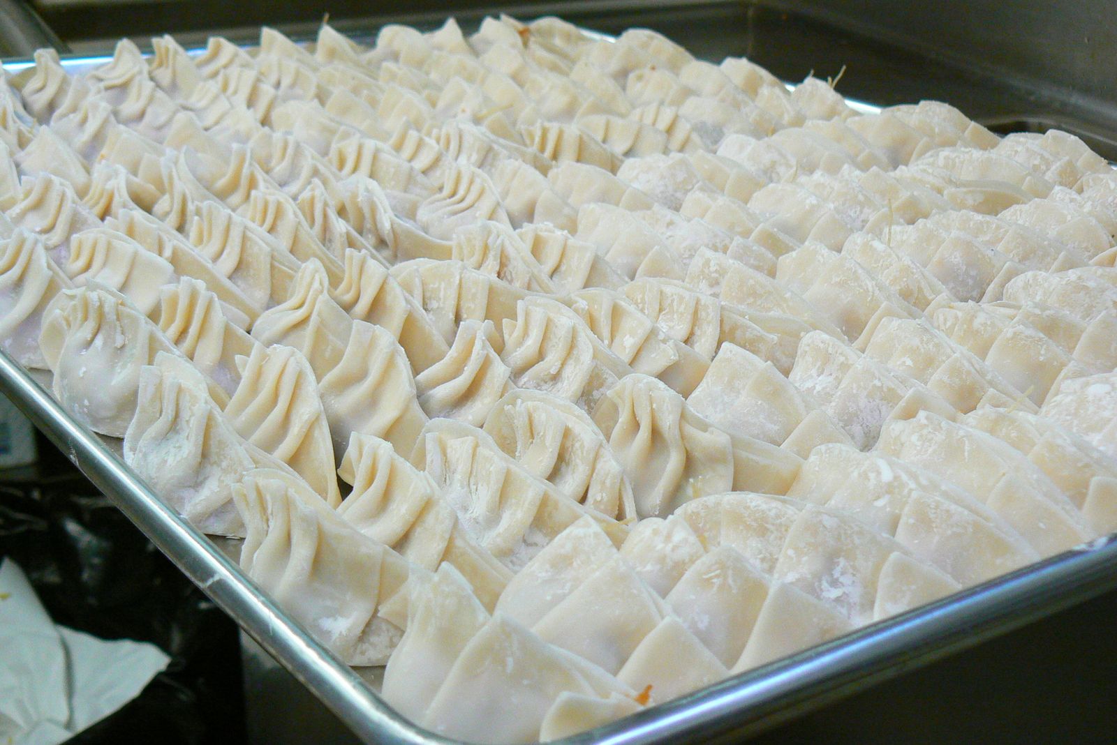 Hand-folded dumplings on a tray
